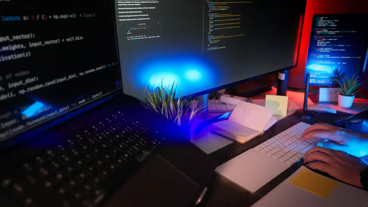 Developer workspace with multiple monitors showing code, representing the ideal setup for technical note-taking and productivity