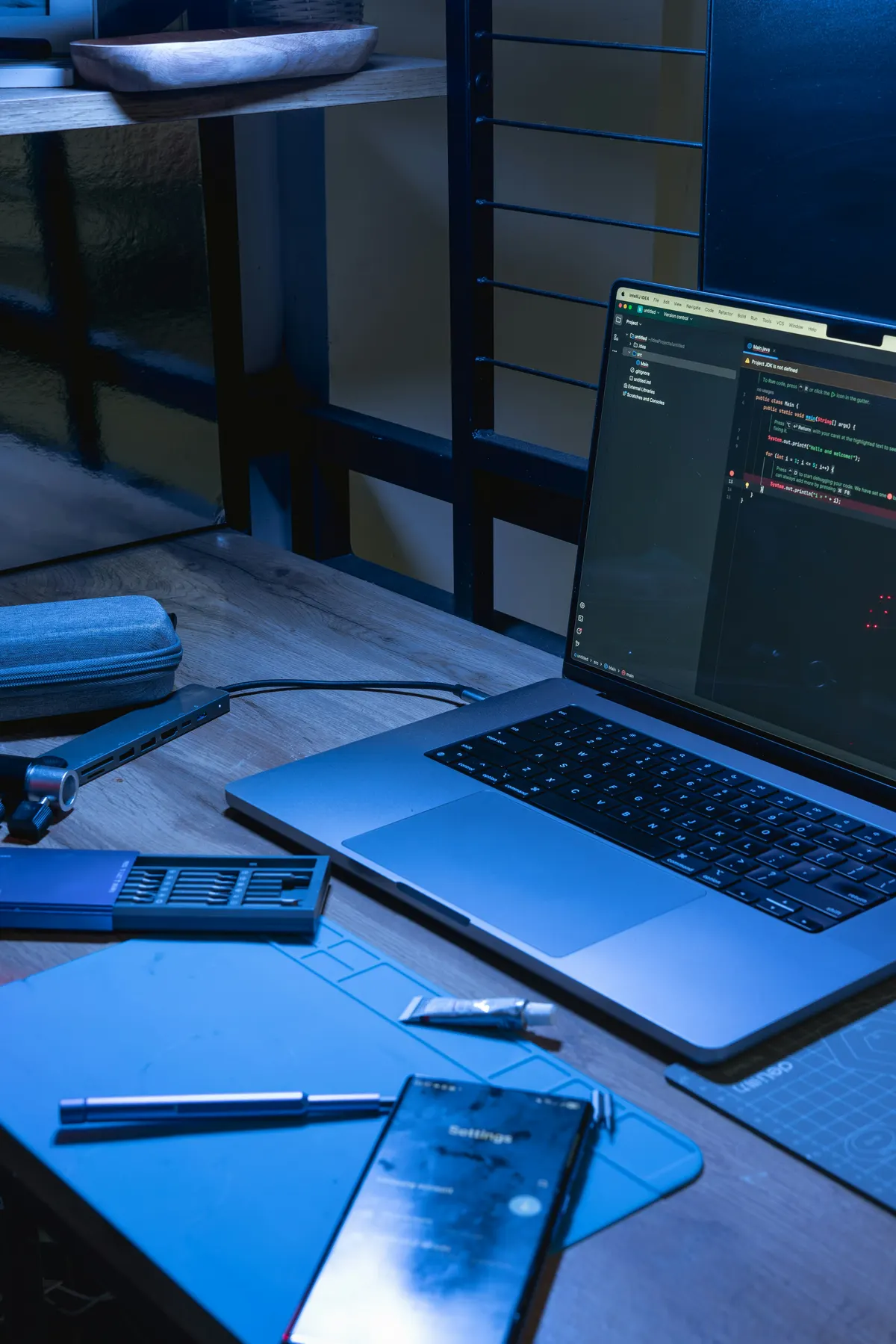 Developer working on laptop with code editor and development environment visible